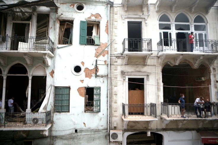 Damaged buildings featuring traditional triple-arch windows are seen in Beirut's Mar Mikhael neighbourhood