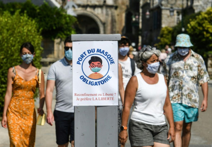 Paris has joined a growing number of French cities requiring people to wear a mask on the street where crowds congregate, like the western town of Locronan where the sign instructing passersby to put on masks asks whether they prefer a lockdown or liberty