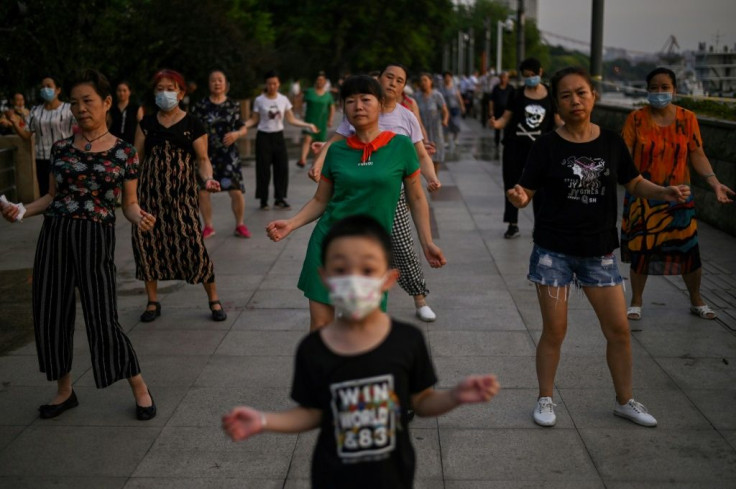 People dancing next to the Yangtze River in Wuhan