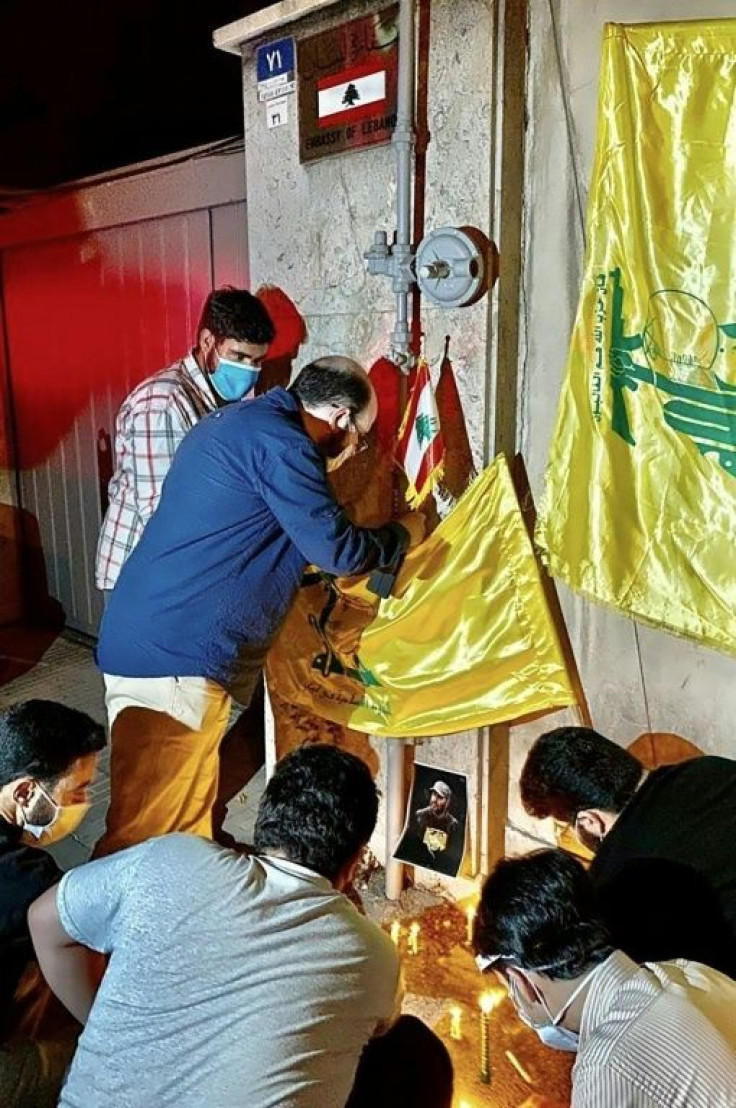 Iranians express solidarity with Lebanon by lighting candles and placing flags of the Iran-backed Lebanese Hezbollah movement in front of  Lebanon's embassy in Tehran