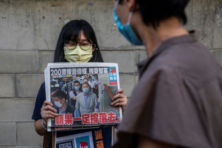 Hong Kongers bought copies of pro-democracy newspaper Apple Daily and shares in its parent company to voice support for its arrested owner