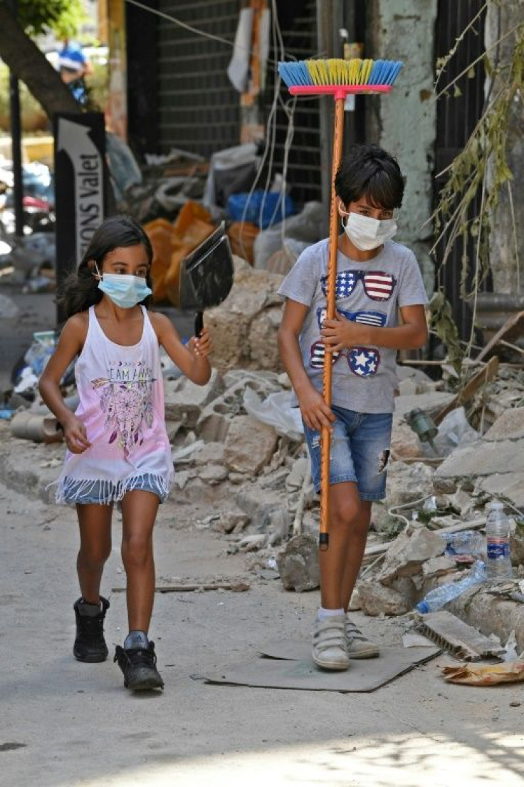 Lebanese children walk in Beirut's Gemmayzeh neighbourhood days after a monster explosion killed more than 150 people and disfigured the Lebanese capital