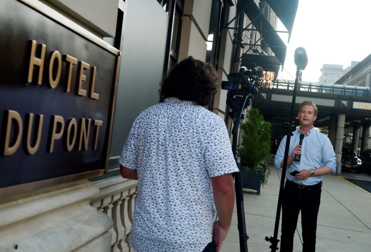 A reporter and cameraman do a live shot outside Hotel du Pont in Wilmington, Delaware, after Democratic presidential nominee Joe Biden named US Senator Kamala Harris of California as his running mate in the 2020 presidential race