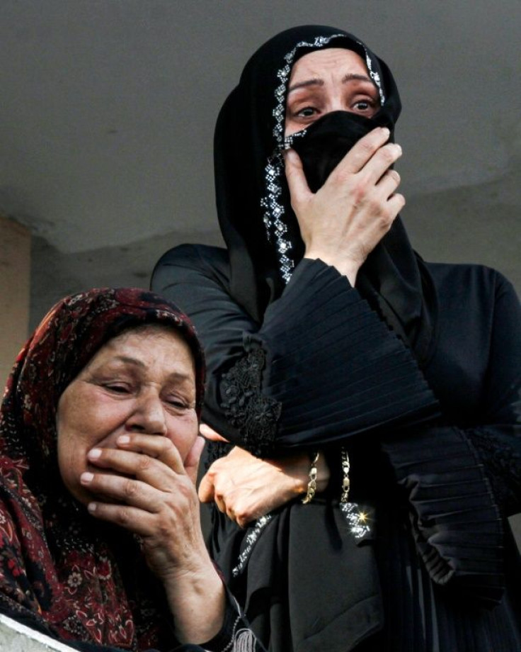 Family members of Imad Zahr al-Din, a worker at the port of Beirut who was killed in the massive explosion, mourn during his funeral at his home village of Burj Rahal, near Tyre in southern Lebanon