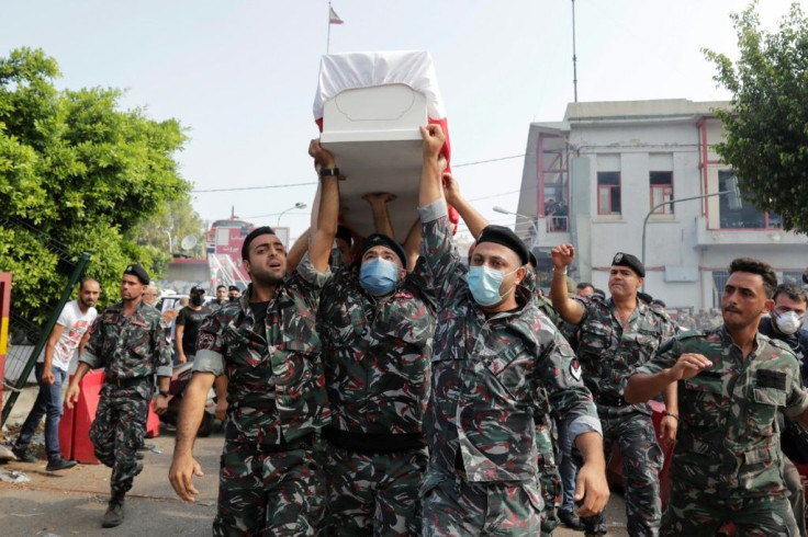 Firefighters carry the coffin of their colleague Joe Noun, who was killed in Beirut's massive blast, during his funeral at the fire station in Karantina neighbourhood near the port