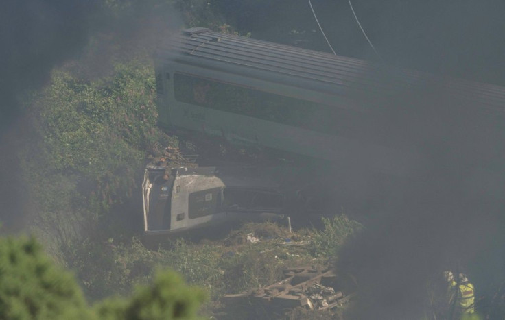 Emergency services personnel work at the scene of a train crash near Stonehaven in northeast Scotland.