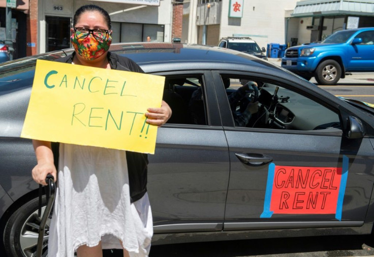 Ady Carrillo poses in front of her car during the "Cancel Rent" protest and caravan in Los Angeles -- a movement that is gaining ground in the United States as an evictions crisis looms