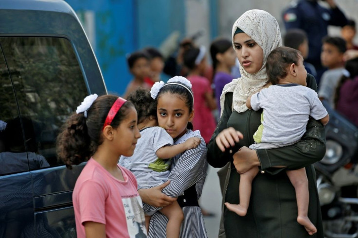 A Palestinian mother picks up her children from a school run by the United Nations Relief and Works Agency in Gaza City