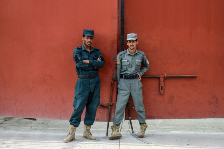 Security personnel stand guard at the prison where the Taliban prisoners to be released are being held