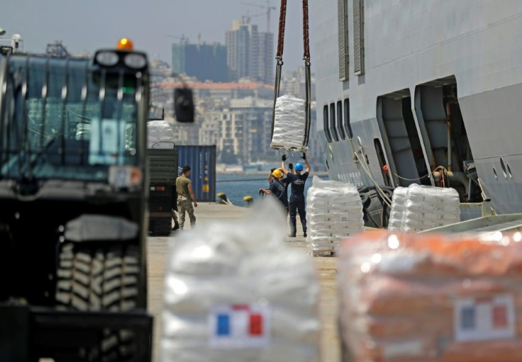 Food and construction materials are unloaded from the French helicopter carrier Tonnerre after it docked in what is left of the port of Beirut