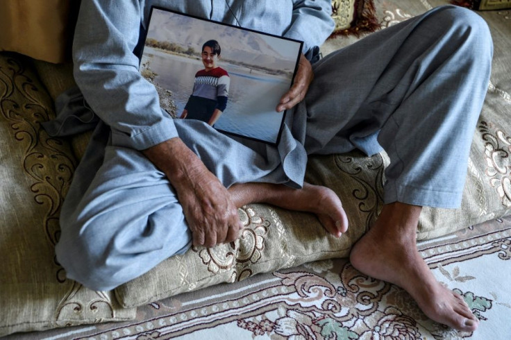 Juma Khan, 77, holds a picture of his son Aziz Ahmad Naween, who was killed in a massive truck bombing near the German embassy in Kabul in 2017