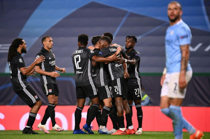 Lyon players celebrate after Moussa Dembele's second goal which sealed their 3-1 win over Manchester City in the Champions League quarter-finals in Lisbon on Saturday
