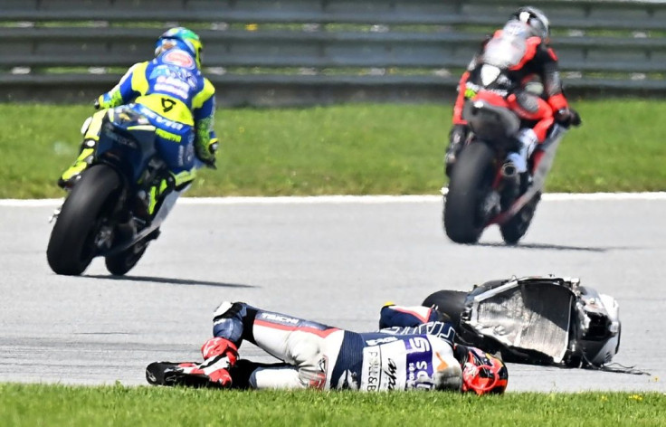 Close call: Malaysian rider Hafizh Syahrin remains down after crashing into the bike of Enea Bastianini in the Moto2 race