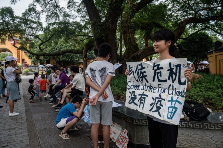 Ou (staging a climate protest in Guilin) has faced run-ins with police, family pressure, and harsh online criticism