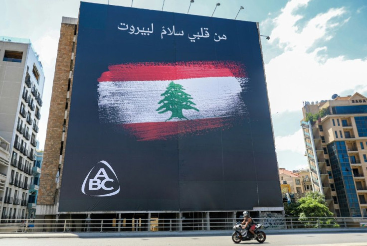 A giant sponsored billboard on a Beirut building abandoned since the end of Lebanon's civil war shows the national flag with the message "From my heart, peace to Beirut"
