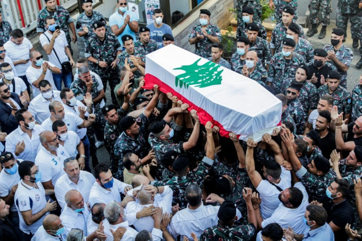 Firefighters carry the coffin of a comrade killed in the monster explosion at the port of Beirut