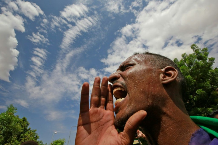 A Sudanese protester calls for justice on the one-year anniversary of the formation of a transitional government