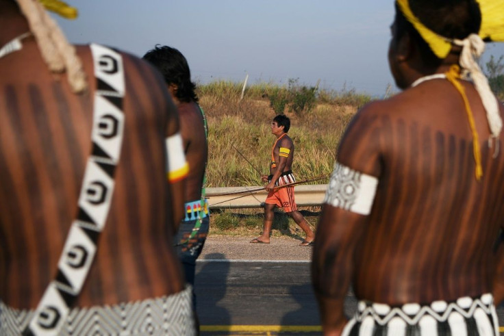 In colorful feathered headdresses, the indigenous protesters wielded sticks, machetes and bows to discourage drivers