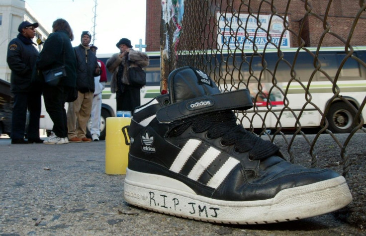 An Adidas sneaker bearing a mourner's message sits on the street outside the music studio in Queens where former Run-DMC member Jason Mizell, known as DJ Jam Master Jay, was shot dead
