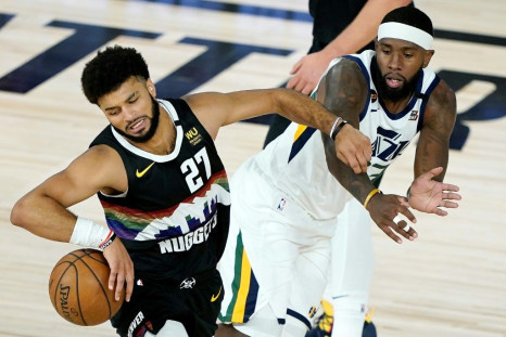 Denver Nuggets Jamal Murray (L) drives against Royce O'Neale of the Utah Jazz during the first half of an NBA playoff game in Florida