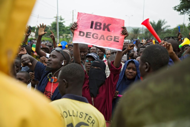 Anger: A demonstrator holds up a sign reading 'IBK out,' referring to President Ibrahim Boubacar Keita by his initials, in a protest in Bamako on August 11