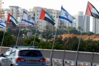 Israeli and United Arab Emirates flags line a road in the Israeli coastal city of Netanya after the countries agreed to establish diplomatic ties