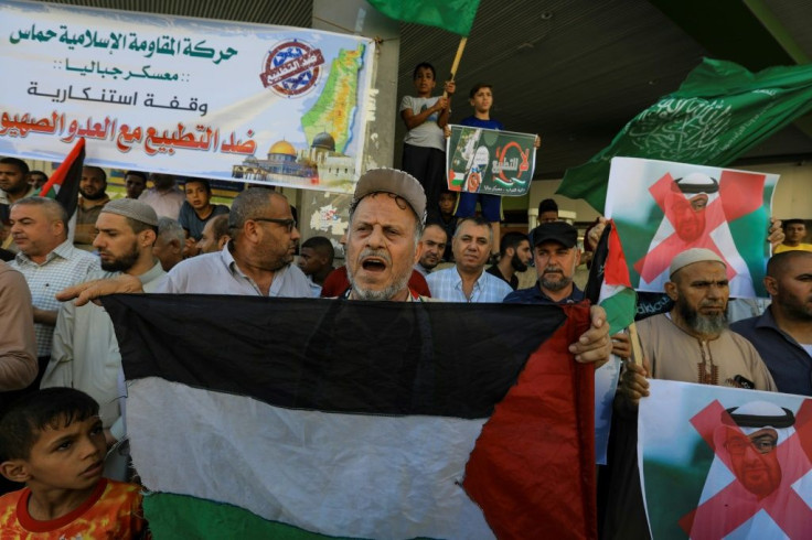 Palestinian demonstrators in the Gaza Strip wave the green flag of the Hamas movement and protest against a US-brokered deal between Israel and the UAE to normalise relations