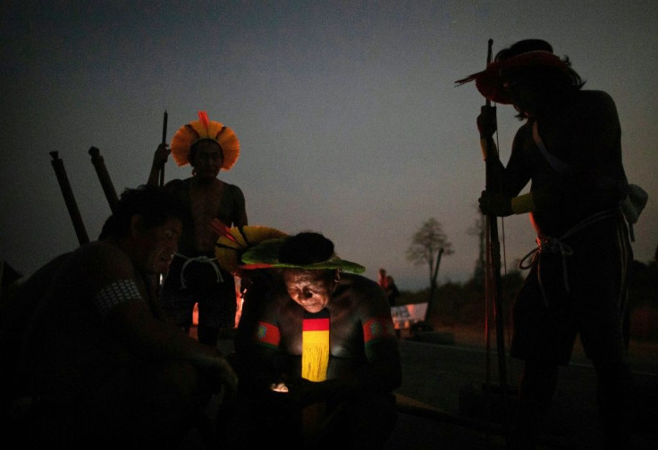 Members of the Kayapo Mekranoti ethnic group check their cell phones during a roadblock outside Novo Progresso, Para state
