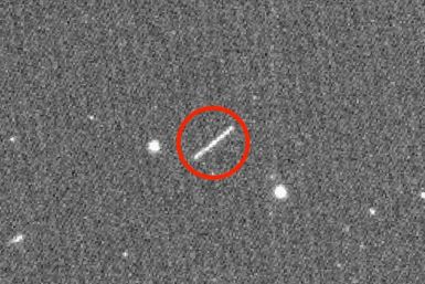 This NASA/JPL/ZTF/Caltech Optical Observatories handout image obtained on August 18, 2020 shows asteroid 2020 QG (the circled streak in the center), which came closer to Earth than any other nonimpacting asteroid on record