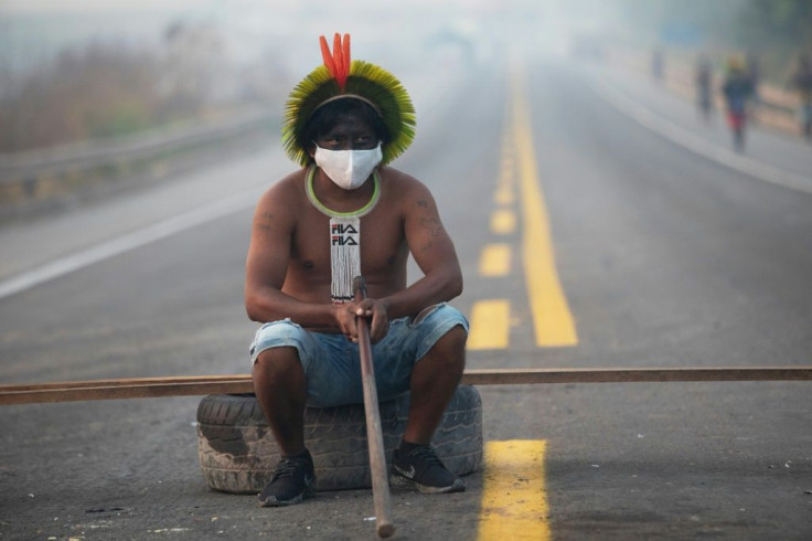 A member of the Kayapo tribe blocks highway BR163 during a protest on the outskirts of Novo Progresso in Para State, Brazi