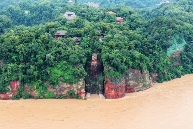 State media footage showed murky floodwaters lapping at the feet of the 71m metre-tall Leshan Giant Buddha in Sichuan - for the first time since the People's Republic of China was founded in 1949