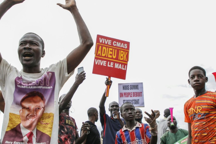 Malians hold up a placard reading 'Long live CMAS (Coordination of movements and associations sympathetic to Imam Mahmoud Dicko) - long live Mali - Good Bye IBK (for Malian President Ibrahim Boubacar Keita) as they demonstrate at Independence Square in Ba