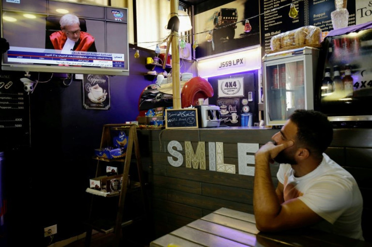 A Lebanese man watches the final verdict session of the Special Tribunal for Lebanon (STL) on former premier Rafic Hariri's assassination in 2005 at a coffee shop in the northern port city of Tripoli