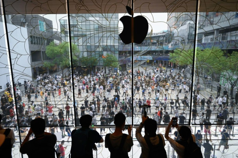 People queue up to enter a new Apple flagship store that opened in Beijing in July 2020