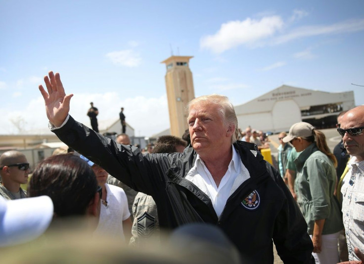 Donald Trump waves to a crowd during a 2017 visit to Puerto Rico, which the US president is accused of wanting to sell