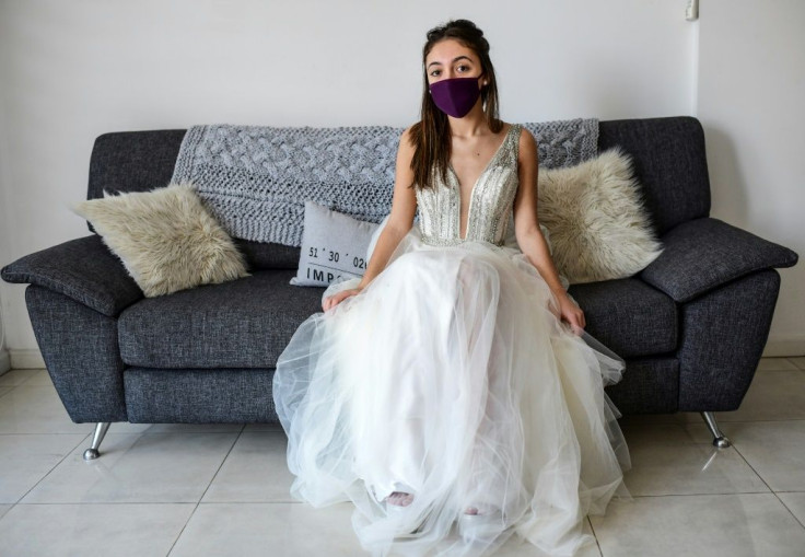 Argentine teen Mia Minutillo poses in the dress she was hoping to wear to her quinceanera that was postponed at the last minute over the coronavirus pandemic
