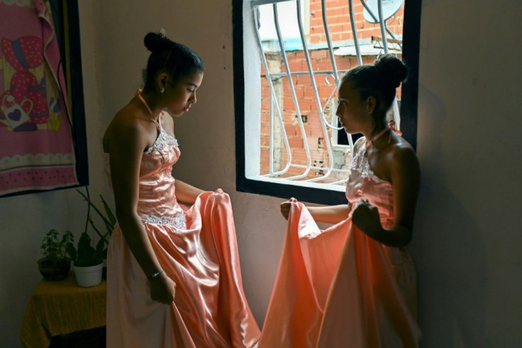 At their quinceanera, Venezuelan half-sisters Sidneidy Uray (L) and Yeikalin Gonzalez wore matching dresses previously worn by Uray's mother and aunt 20 years ago