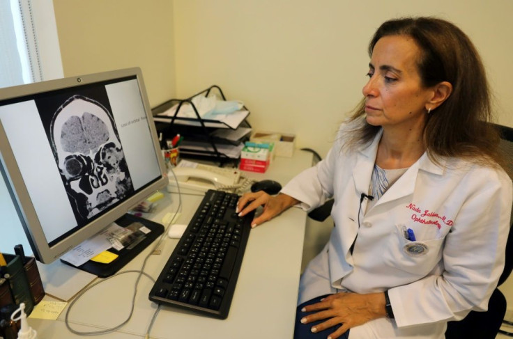 Lebanese doctor Nada Jabbour displays the image of a patient's skull who was hit in the eye with a projectile fired by security forces during an anti-government protest