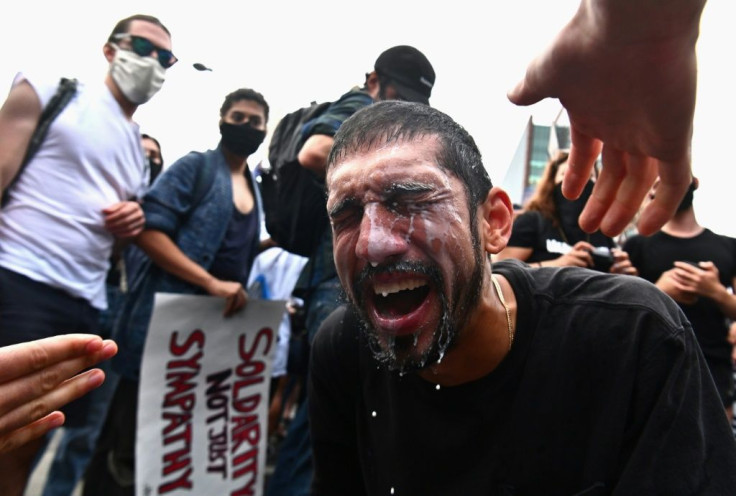 A protester has milk splashed in his eyes after being hit by tear gas during a Black Lives Matter protest in New York on May 29
