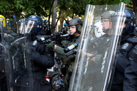 Police in riot gear shoot rubber bullets at demonstrators outside the White House on June 1 during a BLM protest