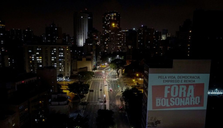 A projection reading "Bolsonaro Out" appears on a building wall during a protest against Brazilian President Jair Bolsonaro in Sao Paulo in May 2020