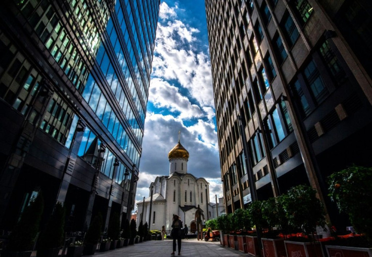 A woman wearing a face mask to protect against the coronavirus disease walks along a street in central Moscow on August 20, 2020