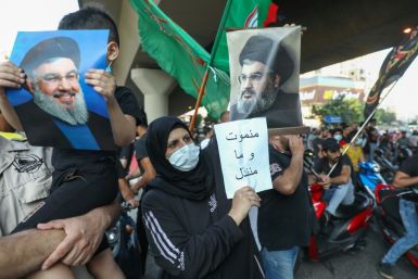 Supporters of Hezbollah hold pictures of leader Hassan Nasrallah during a protest against comments  by the US ambassador to Lebanon criticising the Shiite group back in June