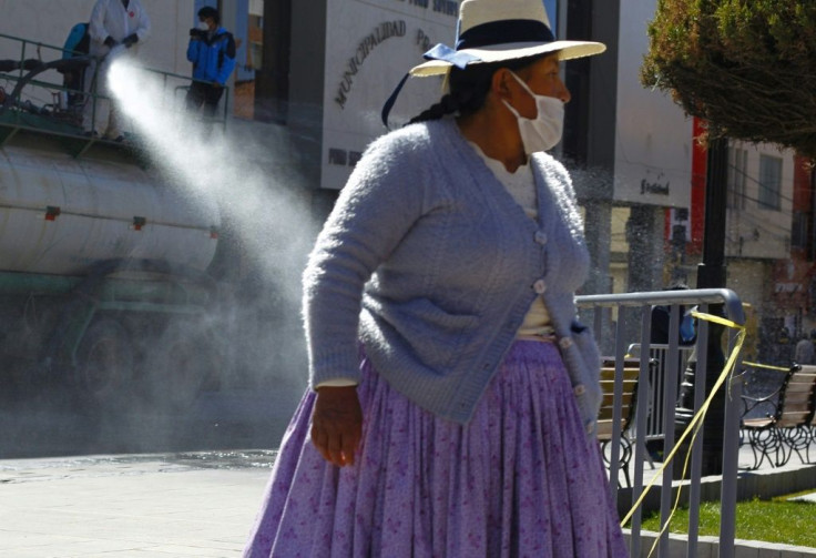 Municipal workers disinfect the streets of Puno, Peru, close to the border with Bolivia, to help combat the spread of the coronavirus