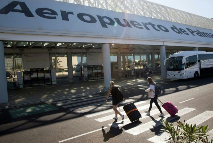Tourists arrive at the Palma airport to leave the island of Mallorca