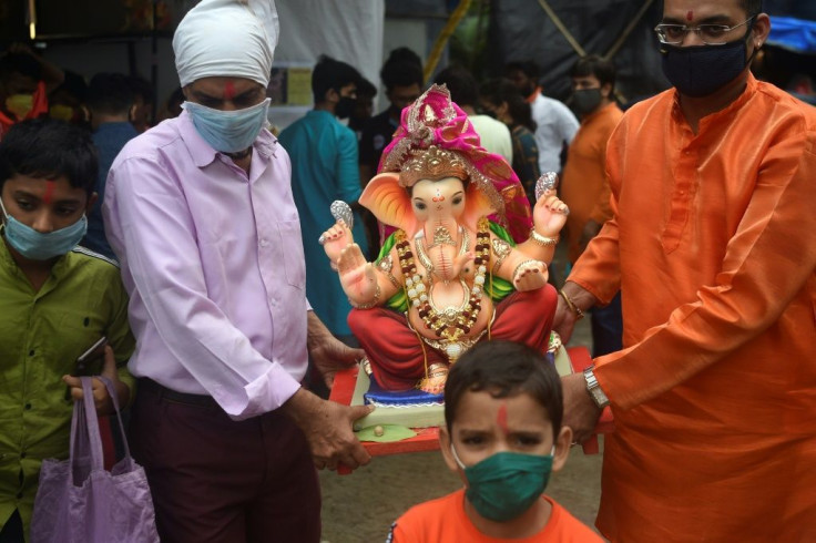 Usually Ganesha idols up to 10 metres high are paraded throught Indian cities for the festival but this year authorities have set a maximum height of 1.1 metres in a bid to cut crowds under anti-virus measures