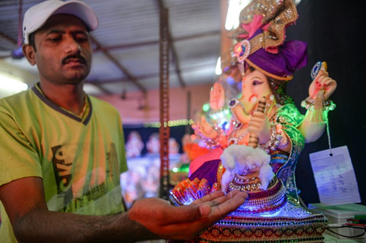 A clay idol of the elephant-headed god Ganesha in Mumbai dispenses hand sanitiser to spread awareness of anti-coronavirus measures