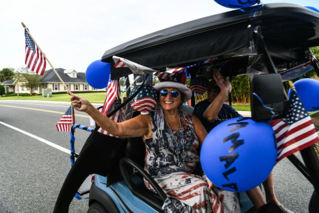 The Villages retirement community in Florida is beset by sharp political divisions -- here a resident rides in a golf cart to celebrate Joe Biden's nomination as Democratic presidential candidate, but not all her fellow seniors agree