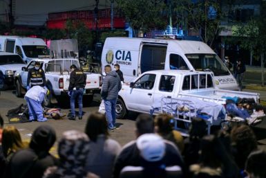 The bodies of 13 people who suffocated in a crush during a police raid in Lima, Peru on August 22 are loaded onto pick-up trucks outside the nightclub where a party was held in violation of a ban on such gatherings imposed to fight COVID-19