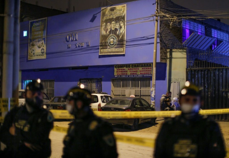 Police stand guard on August 23, 2020 outside the Lima nightclub where 13 people suffocated in a crush during a raid on a party held in violation of a ban on large gatherings during the pandemic